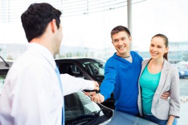 car dealer and couple buying a car