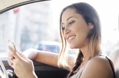 Young female driver in a car driving seat