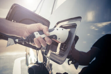 Person placing charger in an electric car