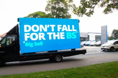 ALA Van in Action with placard reading 'Don't fall for the BS* Big Sell'