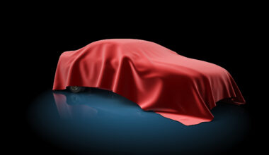 Car covered in luxurious red material so it is hidden