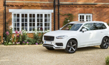 White car parked in the driveway in front of a house