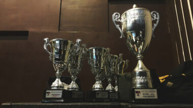 Image of a collection of silver trophies in a cabinet