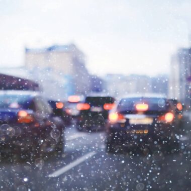 Set of cars in a traffic jam, the image is shown through a rainy window