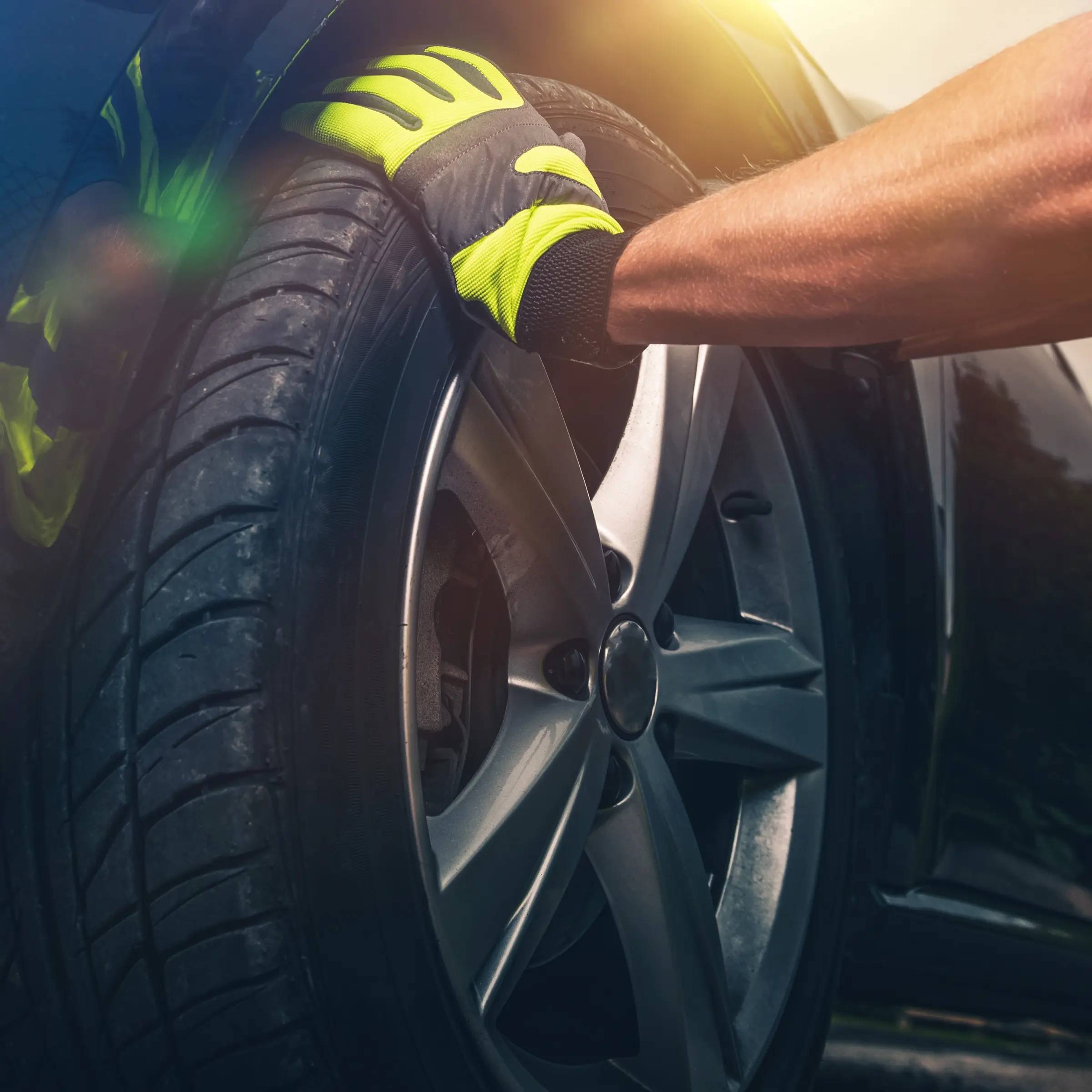 Hand placed on a wheel during repair