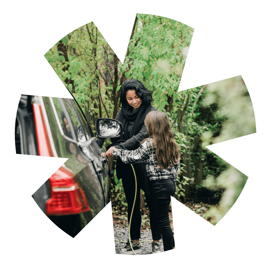 An image in the shape of wheel alloy showing a woman and her daughter plugging in an electric car smiling