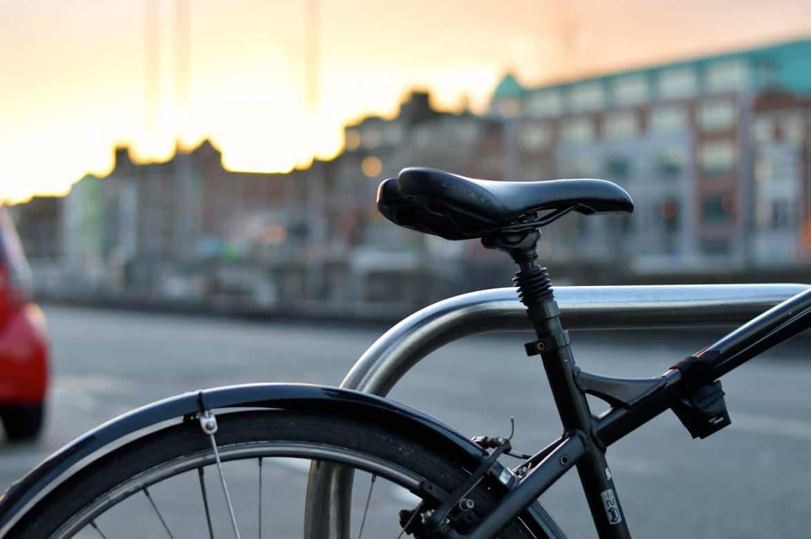 Closeup of a Bicycle resting on a pole