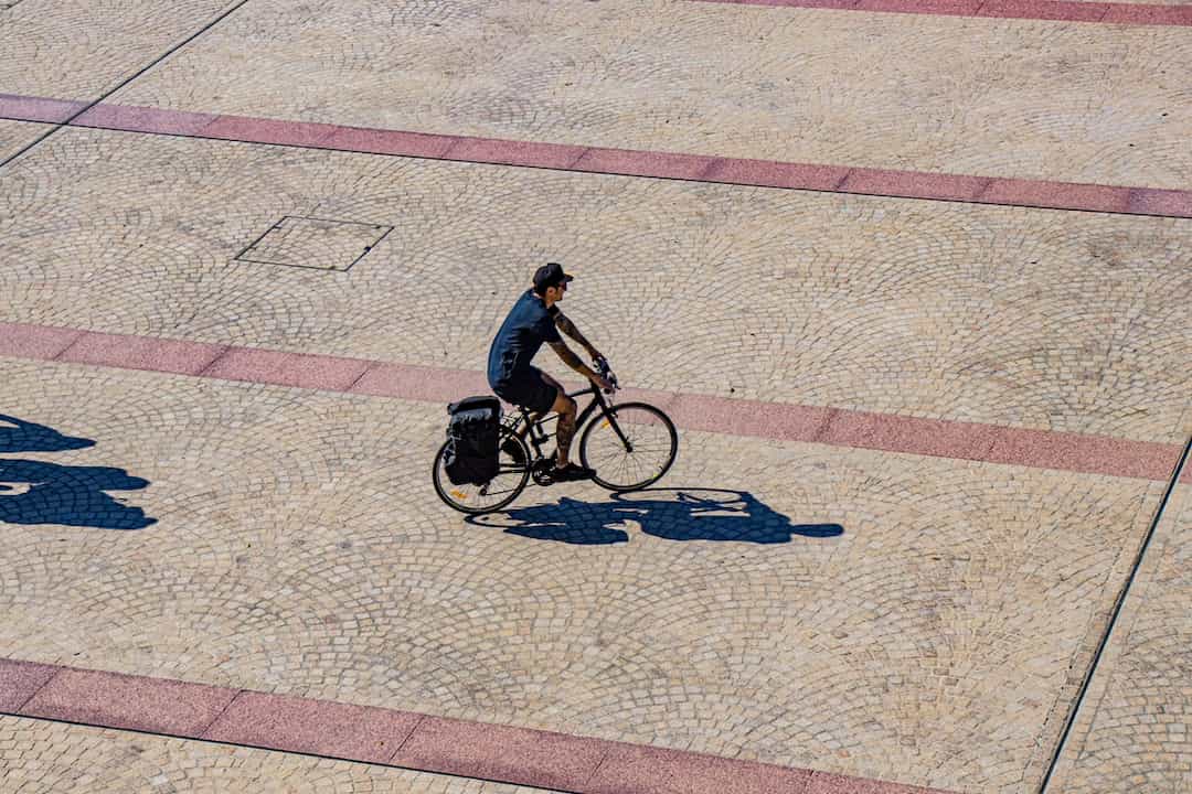 Man cycling across a town centre view from above