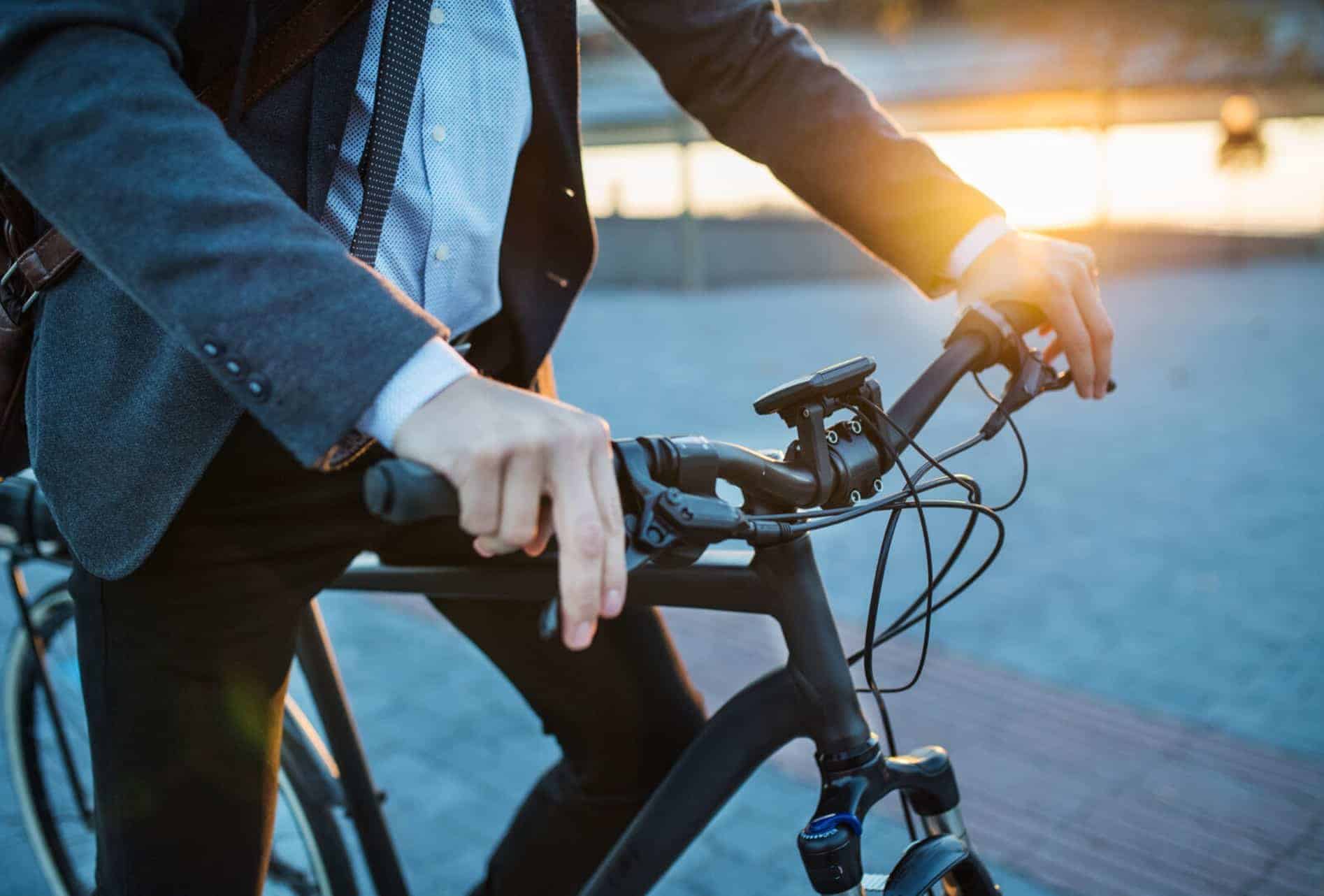 Man sitting on bike, handlebars are the main focal point