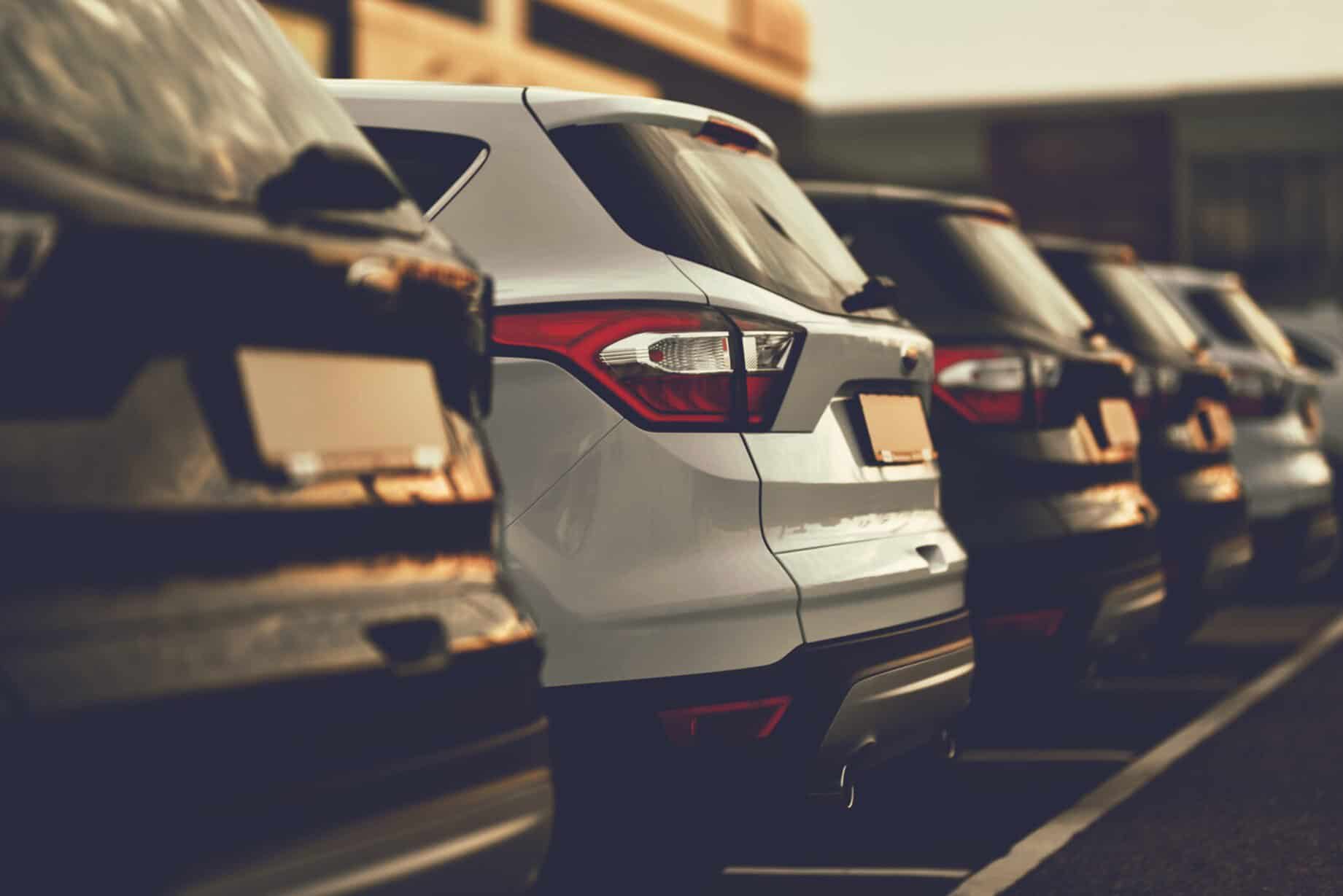 A row of parked cars at a dealership