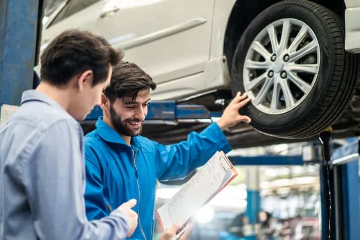 A mechanic explaining the diagnostics to a customer, so the car can undergo repair