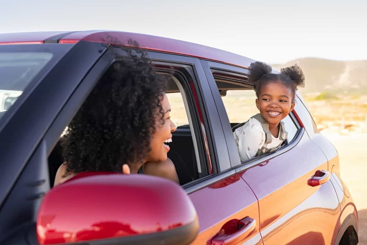 Side view of a car, Mother and child looking at eachother through open windows